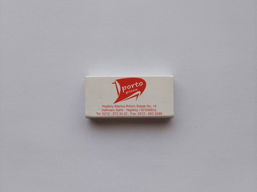 Promotional Porto Balık & Porto Pizza matchbox from Yeşilköy Marina, Istanbul, featuring restaurant branding, address and contact information.