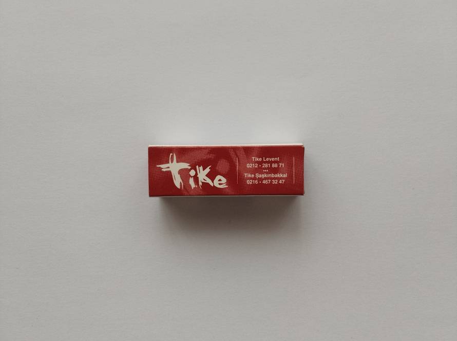 Promotional Tike Restaurant safety matchbox featuring branch contact information for Levent and Şaşkınbakkal on cream-colored sides with a red reverse panel.