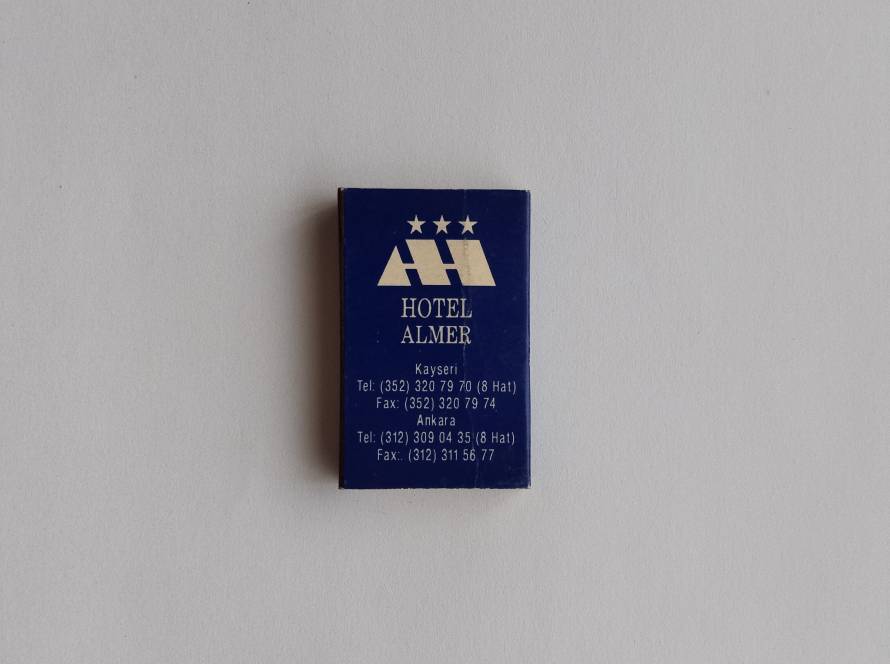 Promotional matchbox for Hotel Almer in Kayseri, featuring the hotel logo with three-star branding and contact information for both Kayseri and Ankara offices.