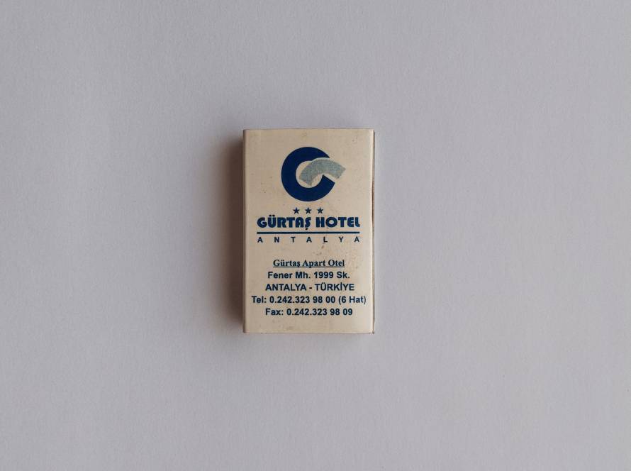 Promotional matchbox for Gürtaş Hotel Antalya, showing hotel branding and contact information for both the main hotel and Gürtaş Apart Otel.