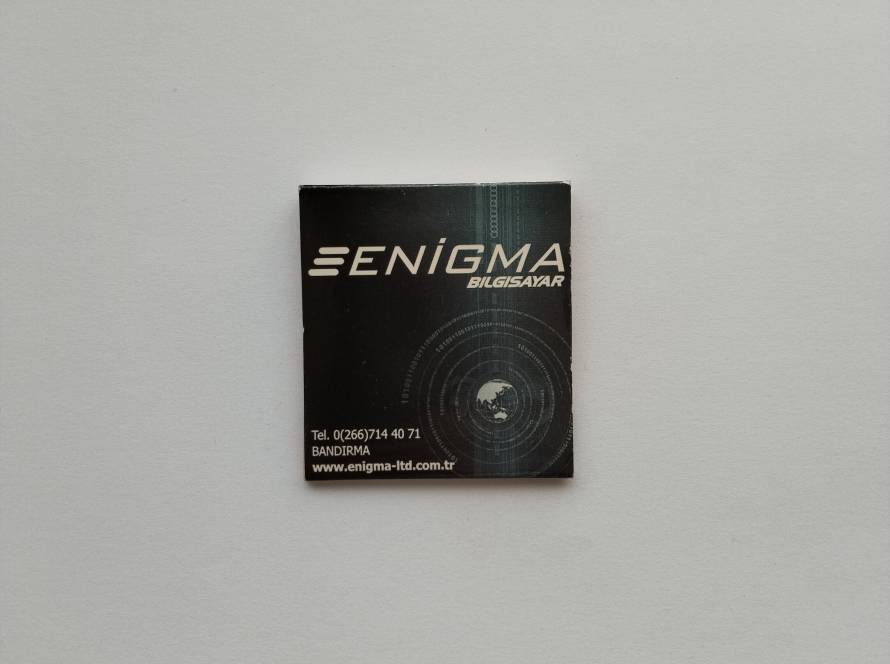 Promotional matchbox for Enigma Bilgisayar, Bandırma. Technology-themed design with globe and digital graphics.