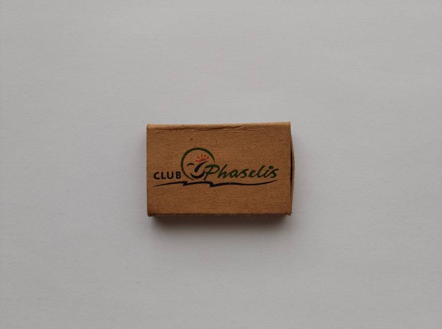 Eco-style kraft promotional matchbox from Club Phaselis, Kemer, Antalya, featuring the resort logo on recycled-style packaging.