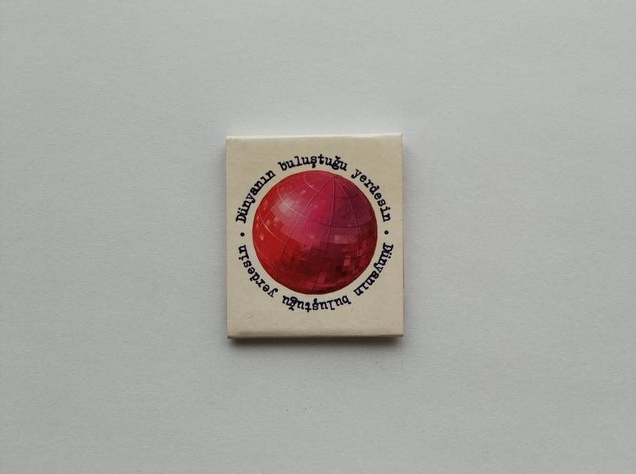 Promotional matchbook featuring a red disco ball and the Turkish slogan "Dünyanın buluştuğu yerdesin" ("You are where the world meets"). Venue/event advertising collectible.